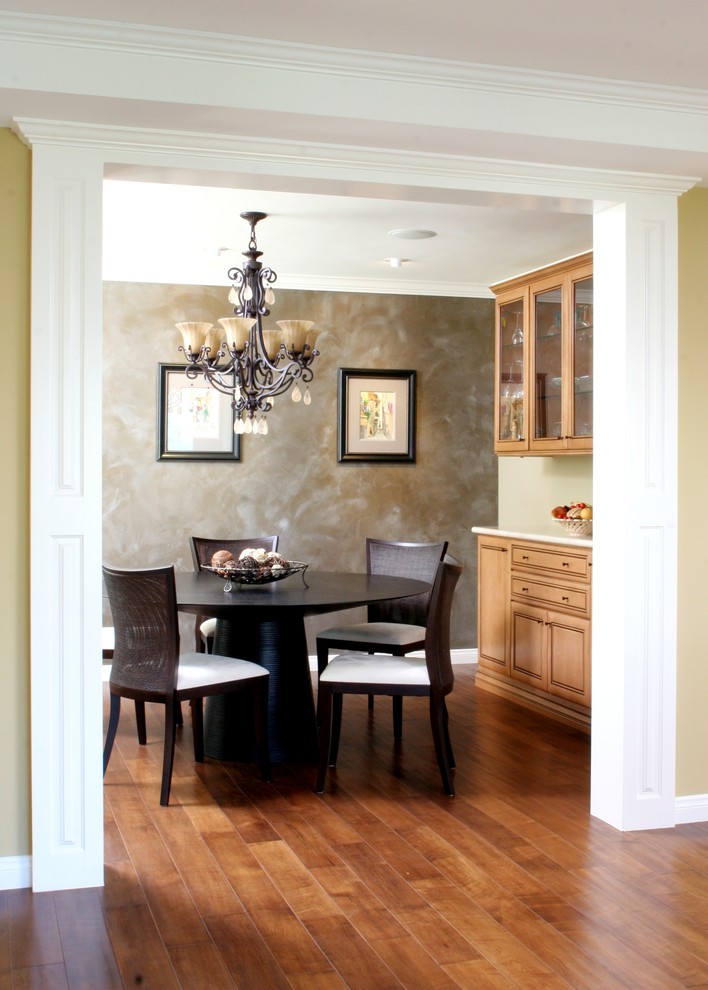 Inspiration for a mid-sized transitional medium tone wood floor enclosed dining room remodel in Orange County with gray walls and no fireplace