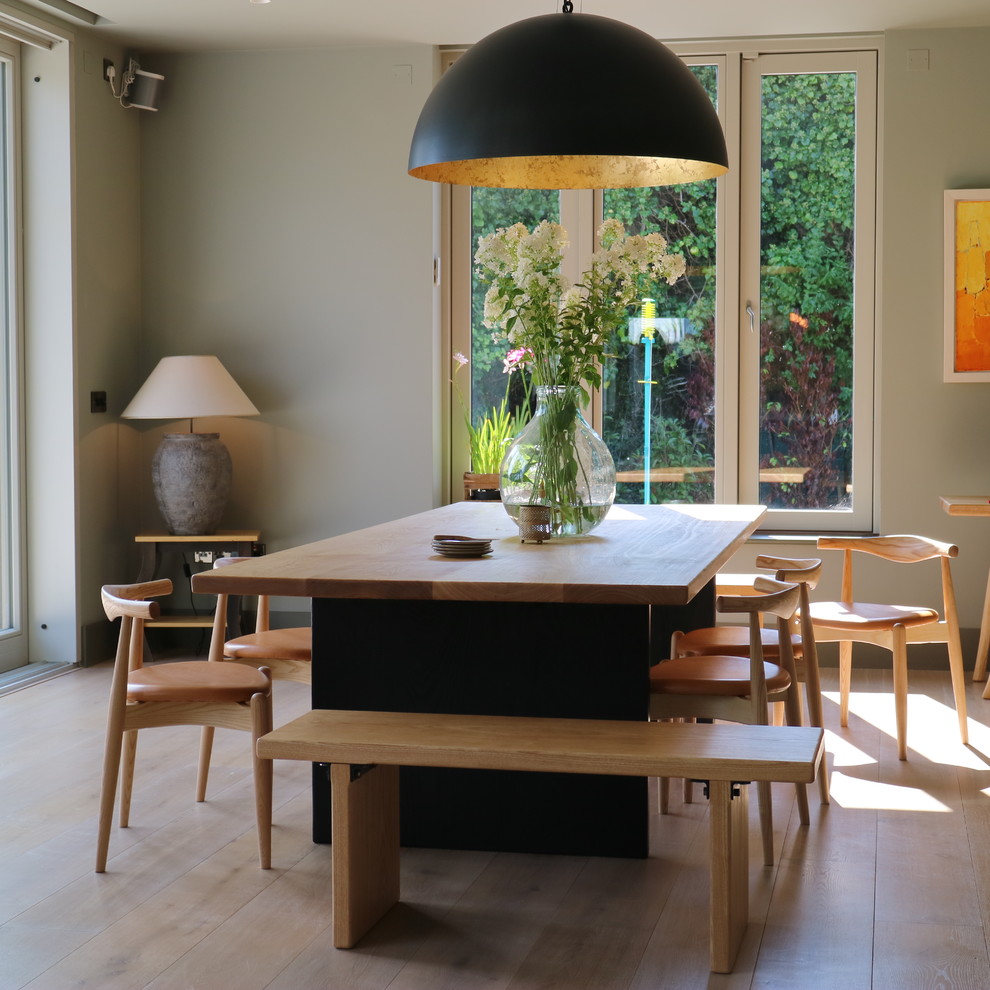 Inspiration for a contemporary dining room in Other with feature lighting.