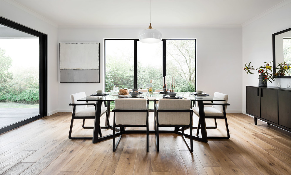 Immagine di una sala da pranzo design con pavimento in legno massello medio e pavimento marrone