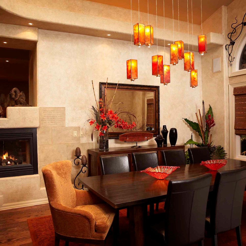 Photo of a medium sized rustic enclosed dining room in Toronto with beige walls, dark hardwood flooring and a standard fireplace.