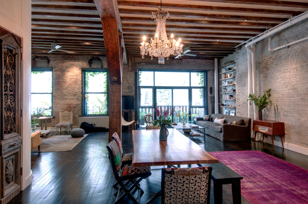 Design ideas for an industrial open plan dining room in New York with dark hardwood flooring.