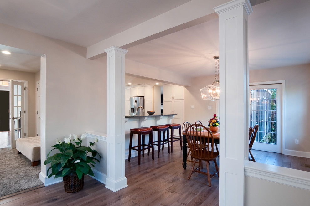 Foto di un'ampia sala da pranzo aperta verso la cucina classica con pareti beige e pavimento in legno massello medio