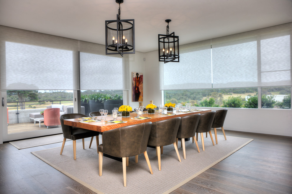 Photo of an expansive contemporary kitchen/dining room in Melbourne with white walls and light hardwood flooring.