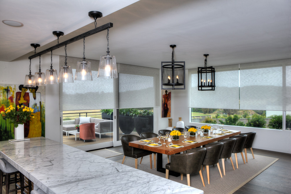 This is an example of an expansive contemporary kitchen/dining room in Melbourne with white walls and light hardwood flooring.