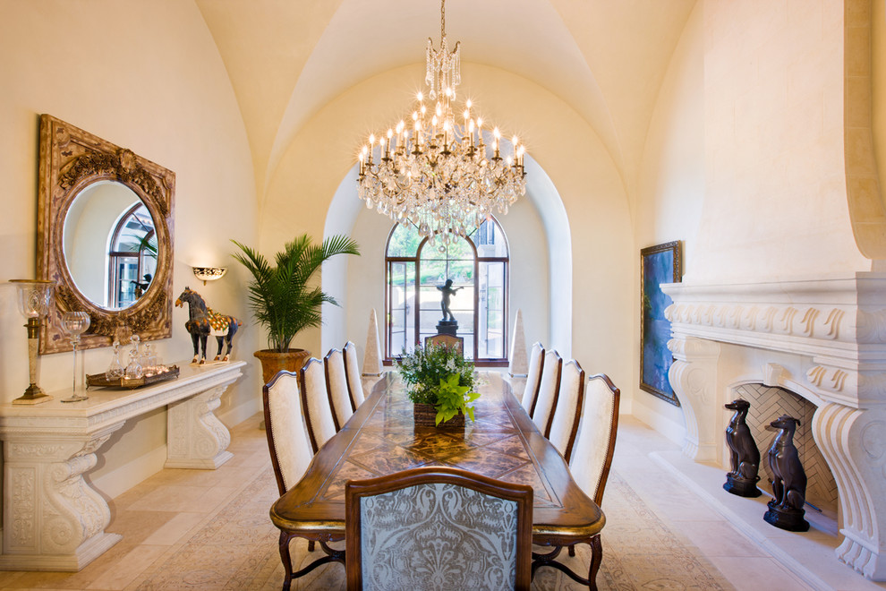 This is an example of a mediterranean enclosed dining room in Austin with beige walls and a standard fireplace.