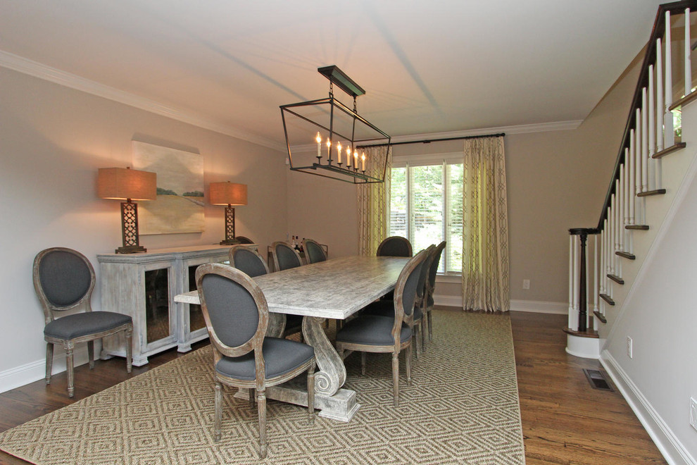 Photo of a large classic enclosed dining room in Atlanta with beige walls, medium hardwood flooring, no fireplace and brown floors.