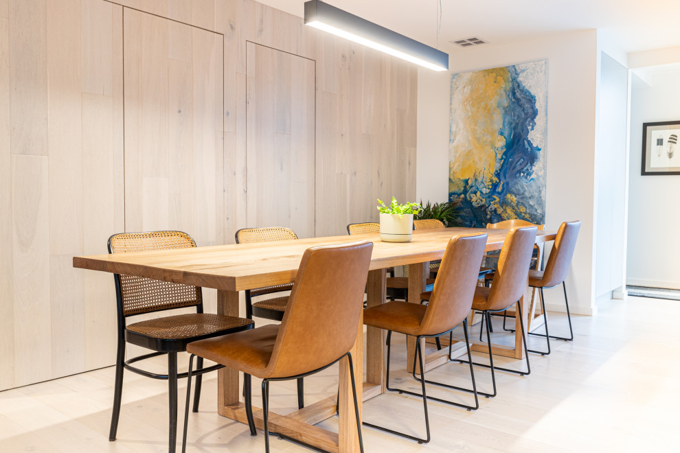 Inspiration for a contemporary light wood floor and beige floor dining room remodel in Melbourne with white walls