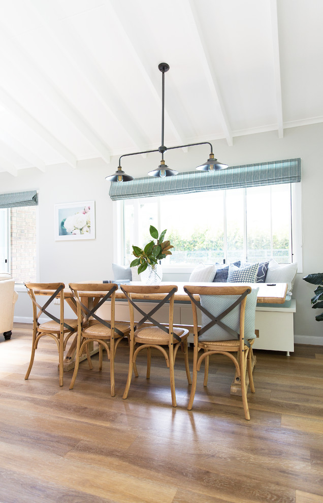 Immagine di una sala da pranzo aperta verso la cucina country con pareti grigie, pavimento in vinile e pavimento marrone