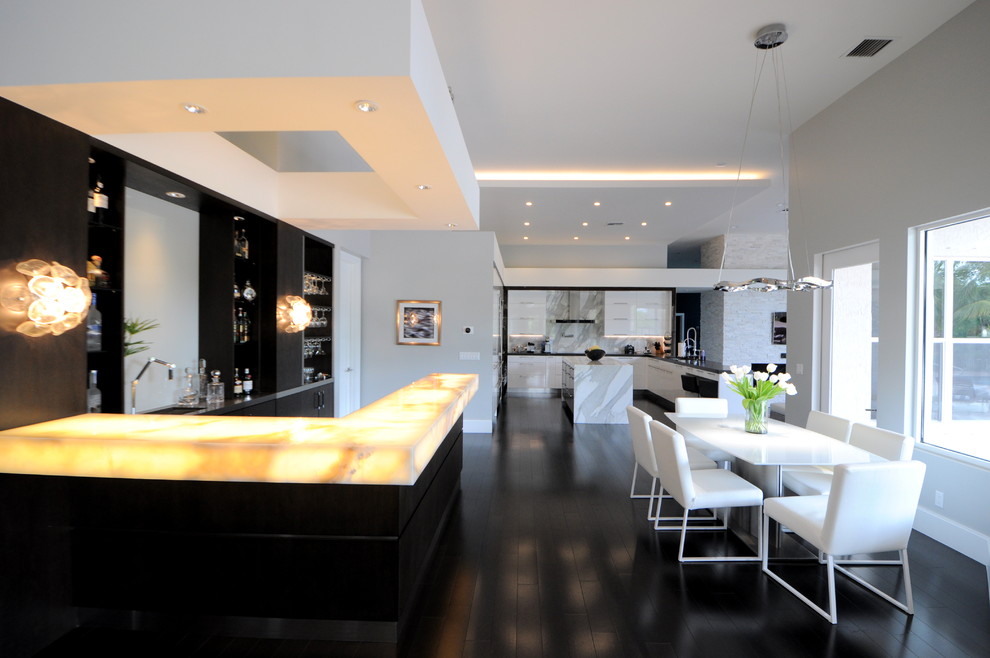 Large minimalist dark wood floor kitchen/dining room combo photo in Miami with gray walls
