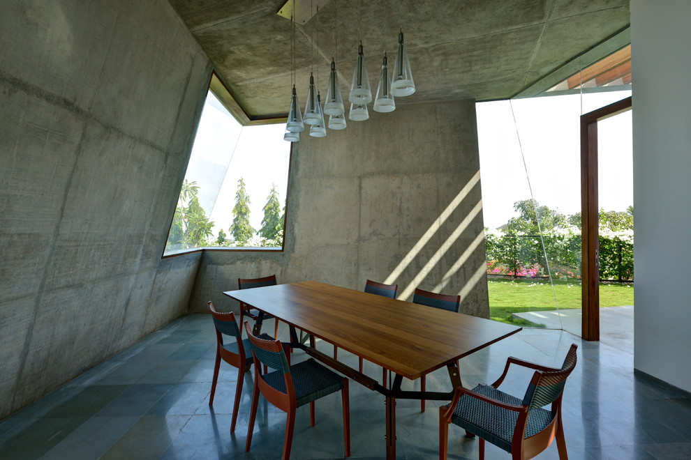 This is an example of a large contemporary dining room in Mumbai.