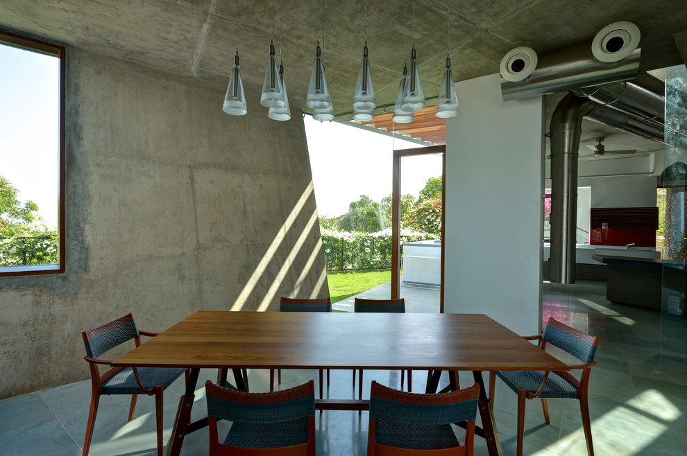 Design ideas for a contemporary dining room in Mumbai.