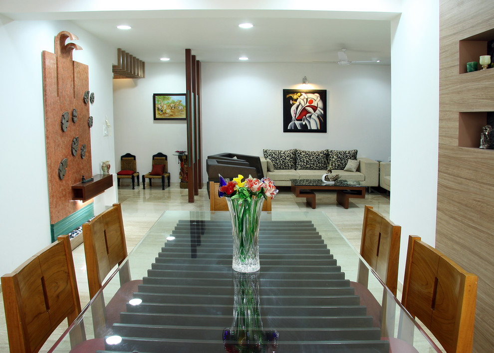 This is an example of a contemporary dining room in Ahmedabad.