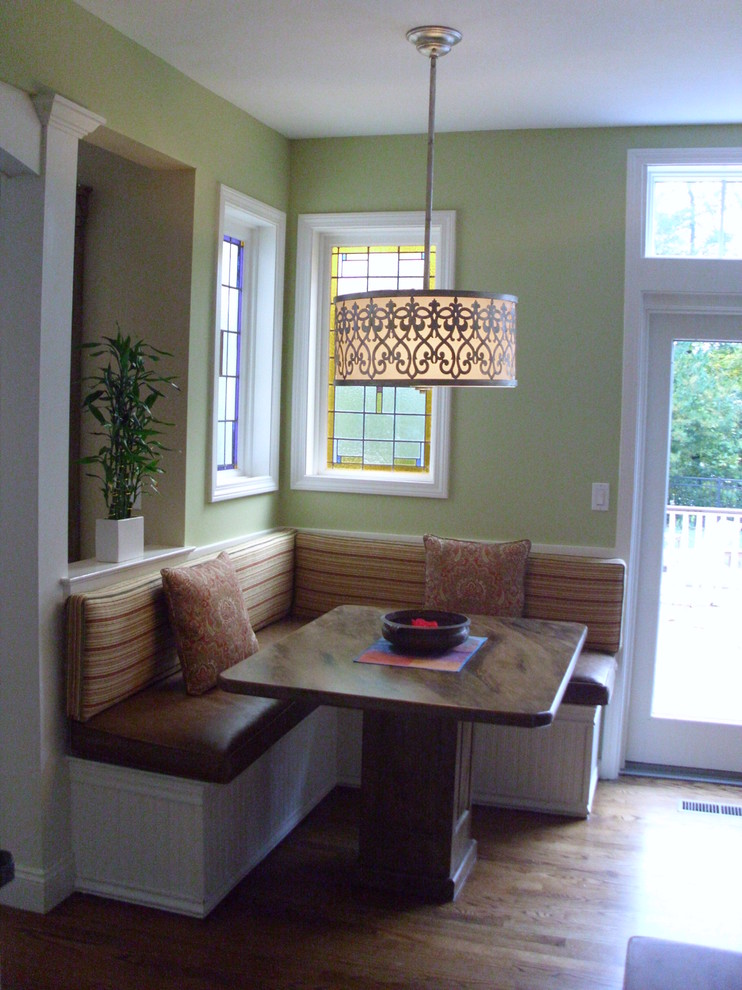Immagine di una sala da pranzo aperta verso la cucina classica di medie dimensioni con pareti verdi, pavimento in legno massello medio, nessun camino e pavimento marrone