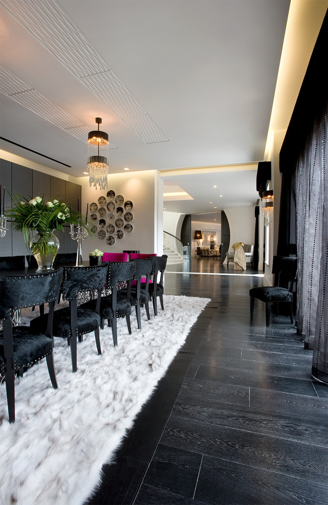 Inspiration for an expansive contemporary open plan dining room in London with white walls and dark hardwood flooring.