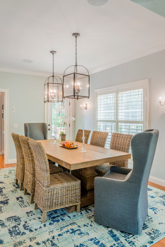 Inspiration for a coastal dining room in Boston with blue walls and light hardwood flooring.