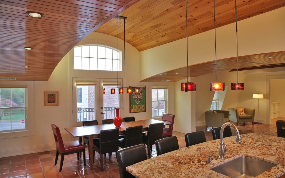 Exemple d'une grande salle à manger ouverte sur le salon chic avec un mur blanc, tomettes au sol et un sol marron.