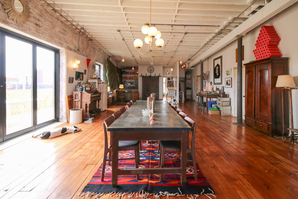 Inspiration for an expansive eclectic open plan dining room in Cleveland with white walls and medium hardwood flooring.