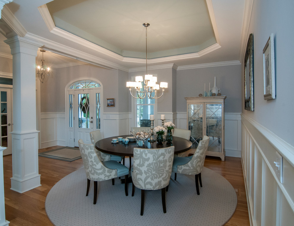 Example of a beach style medium tone wood floor dining room design in Raleigh with gray walls