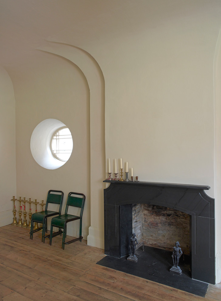 Idée de décoration pour une grande salle à manger tradition avec parquet clair et un manteau de cheminée en pierre.