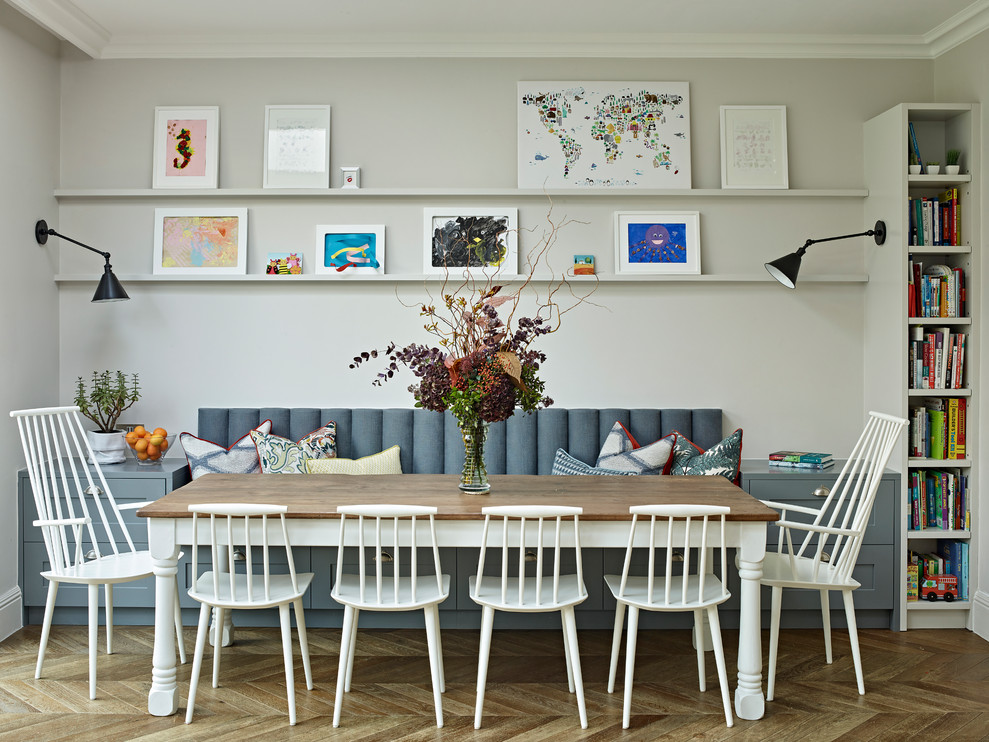 Inspiration for a transitional medium tone wood floor and brown floor dining room remodel in London with white walls