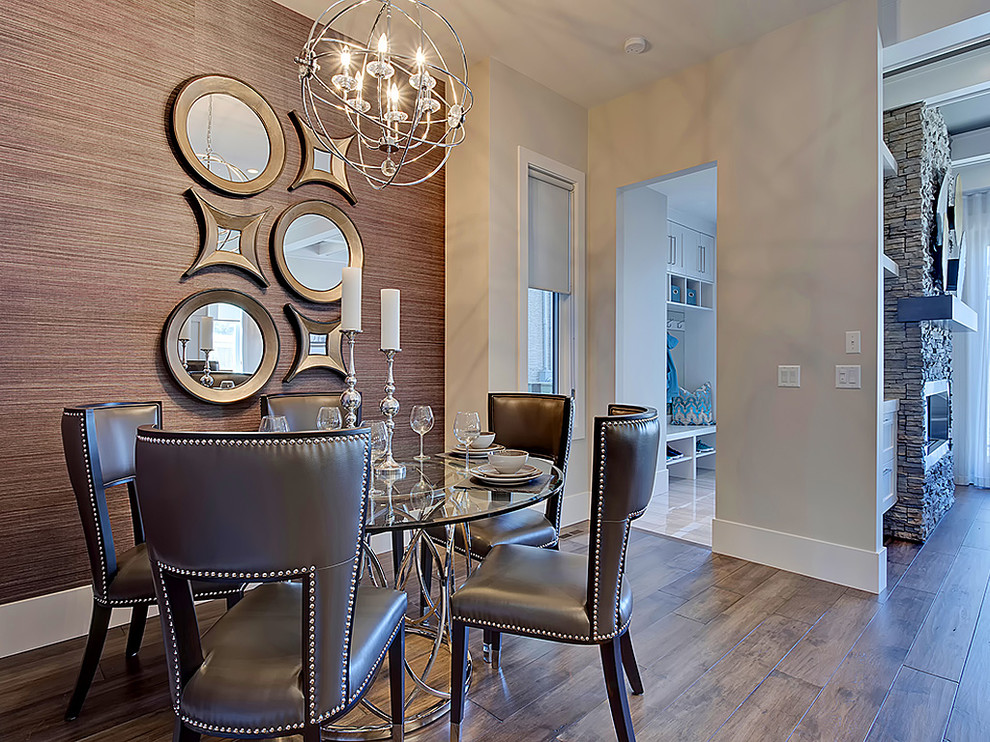 Exemple d'une salle à manger ouverte sur le salon chic de taille moyenne avec un mur beige, un sol en bois brun et cheminée suspendue.