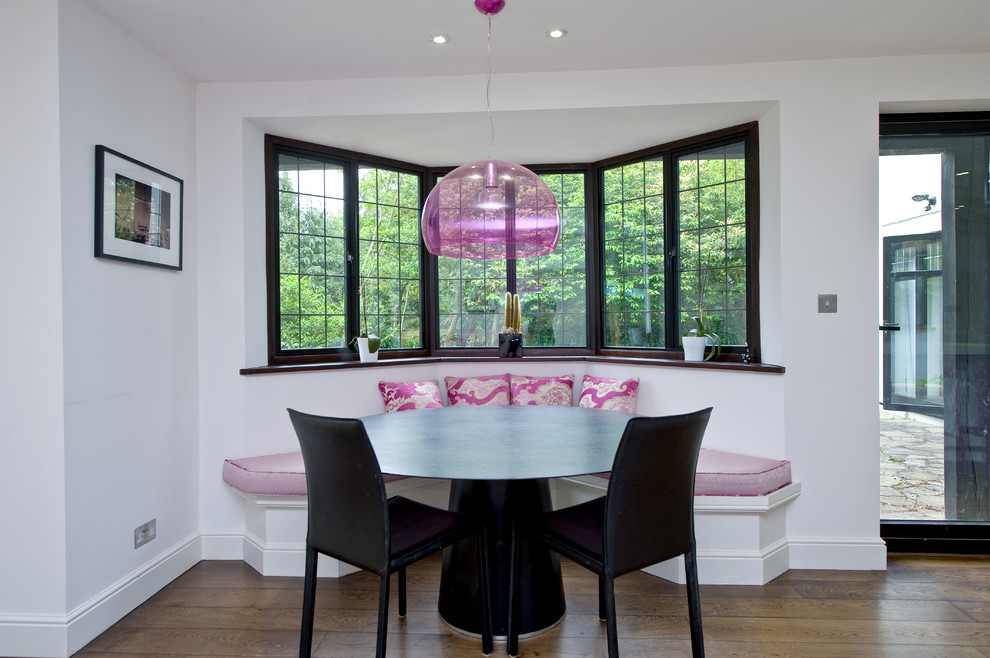 Inspiration for a medium sized contemporary dining room in Surrey with white walls and medium hardwood flooring.