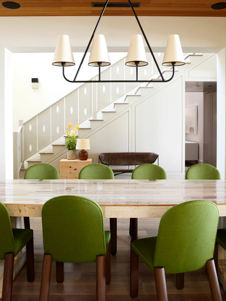 Inspiration for a nautical dining room in Santa Barbara with beige walls and light hardwood flooring.