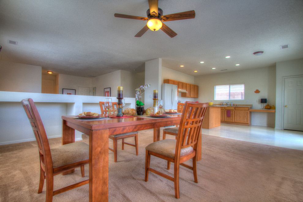 Medium sized kitchen/dining room in Albuquerque with white walls, carpet and no fireplace.