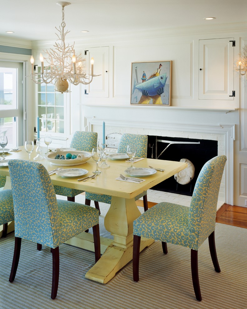 Inspiration for a nautical dining room in Boston with white walls, dark hardwood flooring, a standard fireplace and a brick fireplace surround.