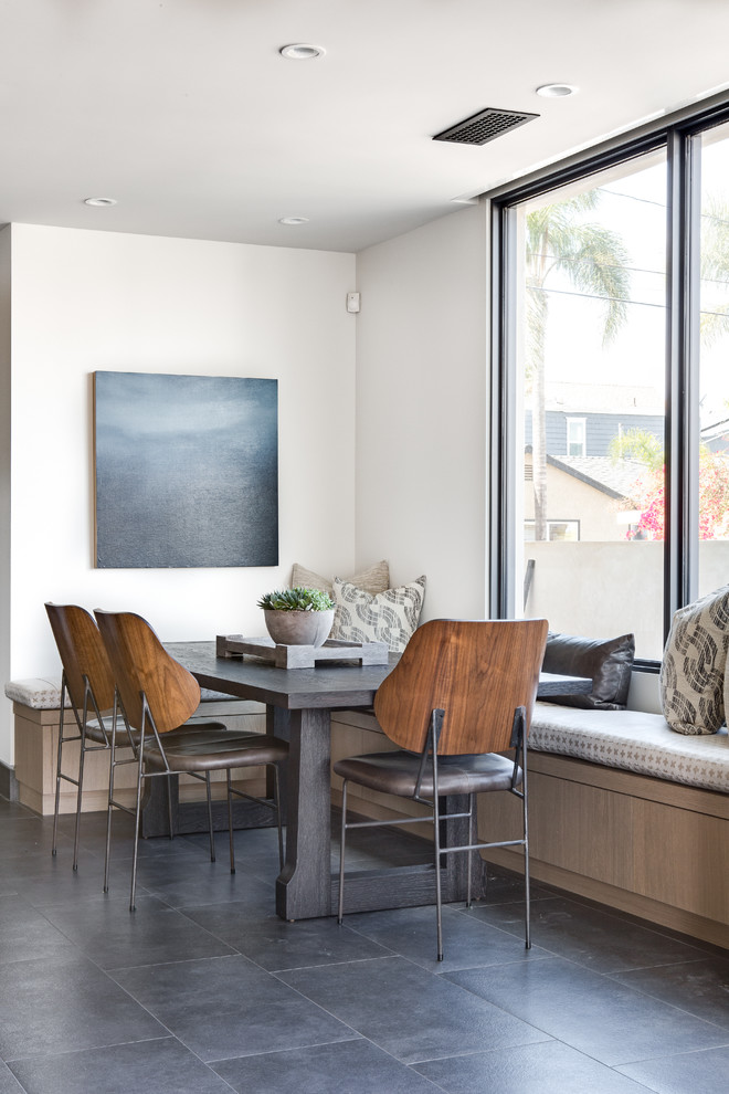 Example of a small trendy gray floor dining room design in Orange County with white walls and no fireplace