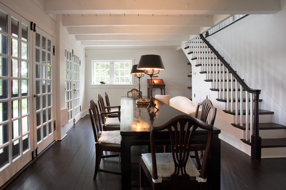 This is an example of a rustic dining room in Philadelphia with white walls and dark hardwood flooring.
