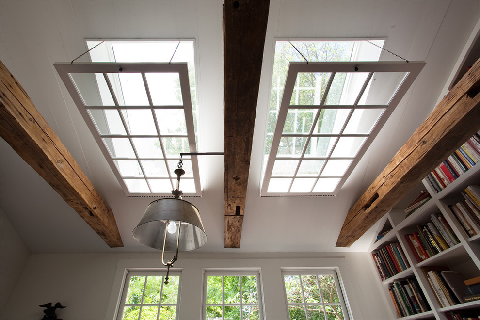 Example of a farmhouse dark wood floor dining room design in Philadelphia with white walls