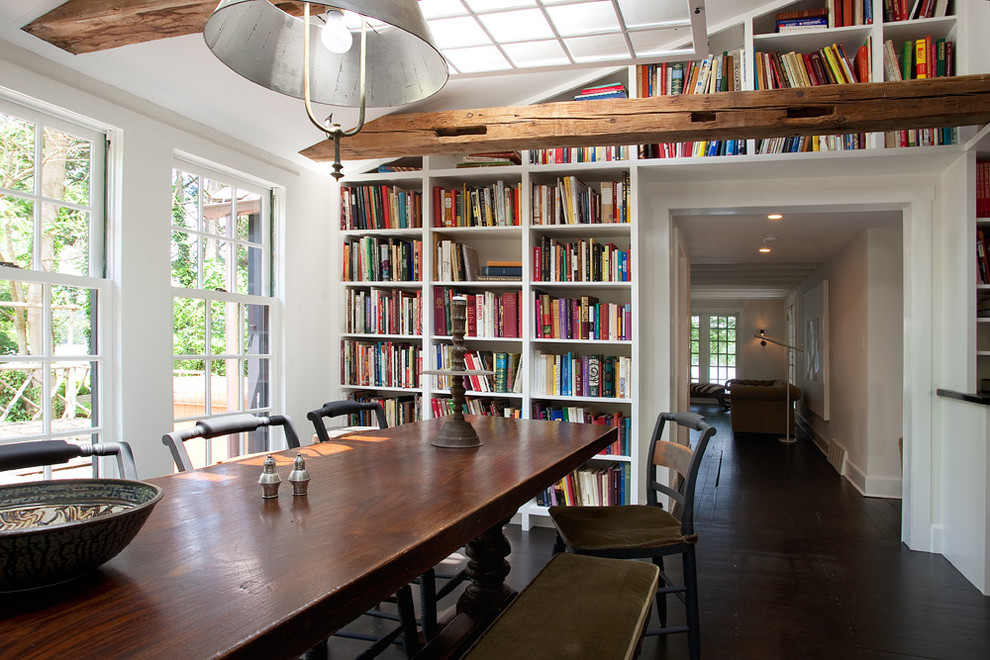 This is an example of a rural dining room in Philadelphia with white walls and dark hardwood flooring.