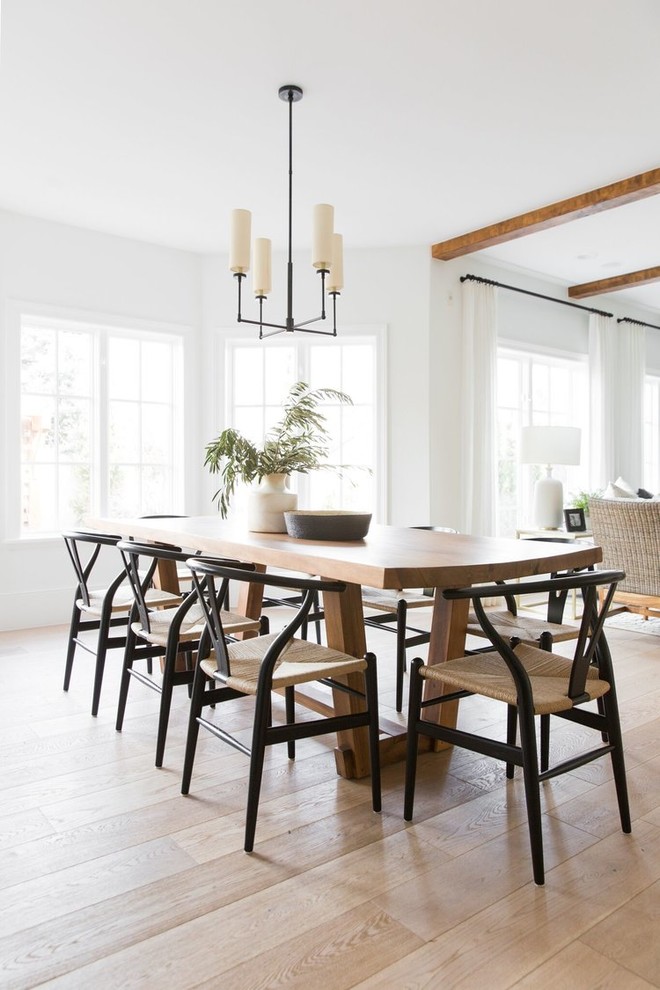 Immagine di una sala da pranzo aperta verso il soggiorno classica di medie dimensioni con pareti bianche e pavimento in legno massello medio