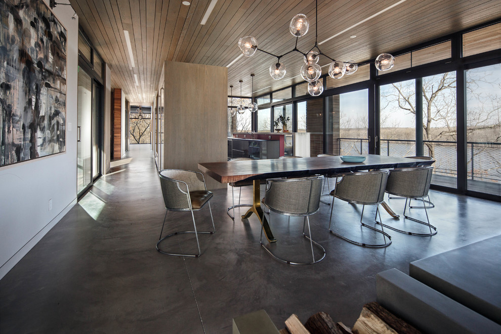 Photo of a contemporary open plan dining room in New York with concrete flooring.