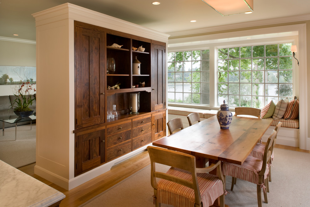 Photo of a traditional dining room in Portland with beige walls and medium hardwood flooring.