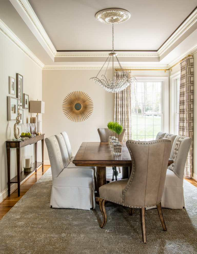 Inspiration for a transitional medium tone wood floor, brown floor and tray ceiling dining room remodel in DC Metro with gray walls