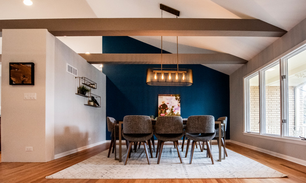 Inspiration for a large 1950s medium tone wood floor and brown floor great room remodel in Chicago with blue walls