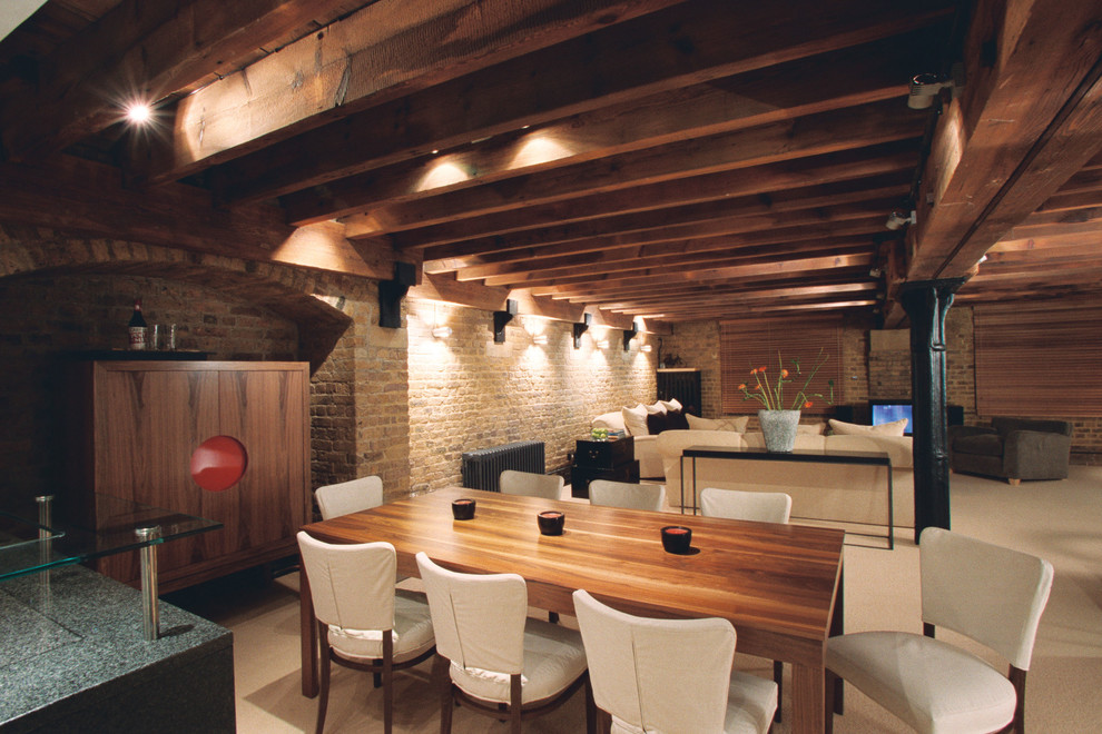This is an example of a large contemporary open plan dining room in London.