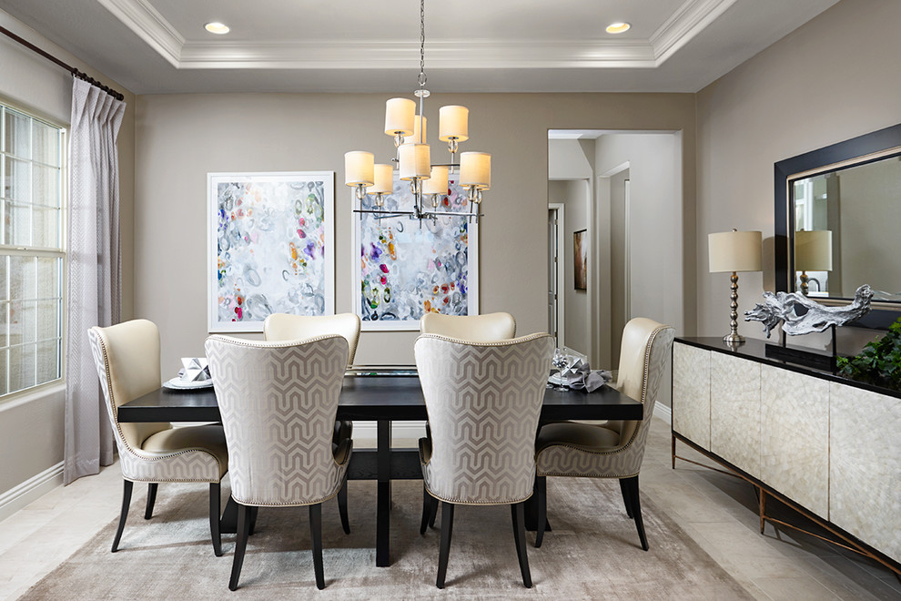Contemporary dining room in Denver with grey walls and grey floors.