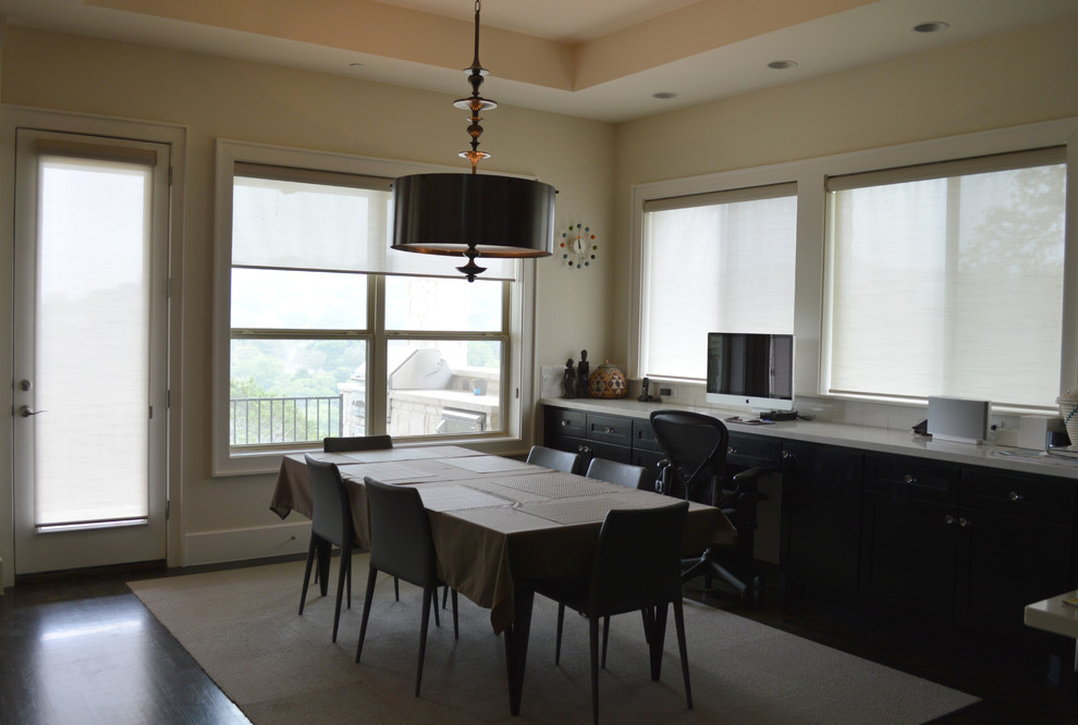 Medium sized modern kitchen/dining room in Austin with white walls and dark hardwood flooring.