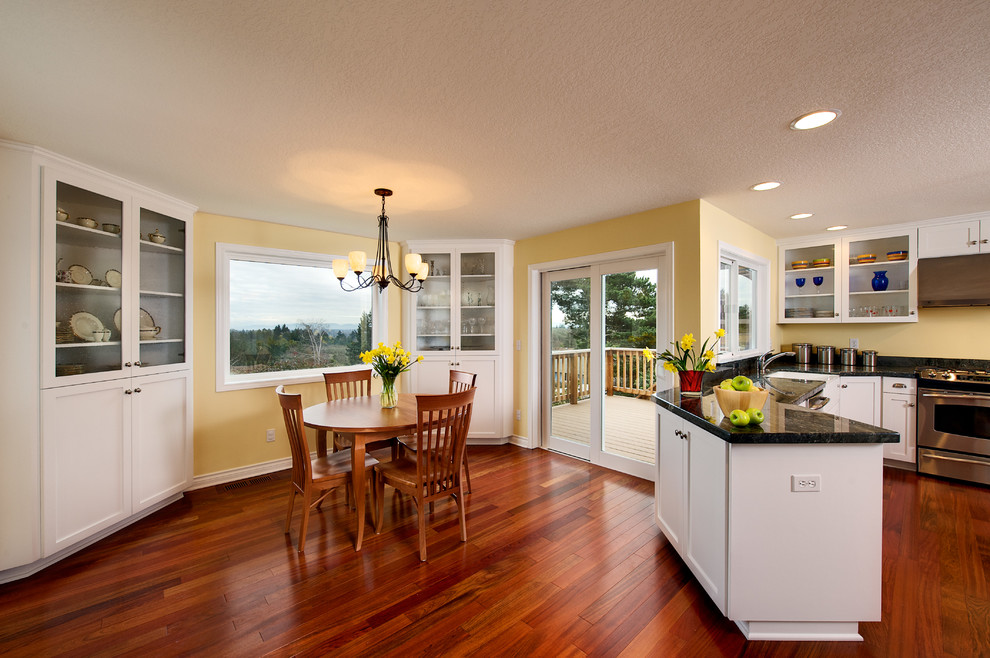 Kitchen/dining room combo - mid-sized transitional medium tone wood floor kitchen/dining room combo idea in Other with yellow walls