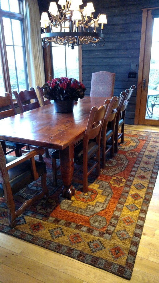 This is an example of a large traditional kitchen/dining room in Denver with black walls, light hardwood flooring and yellow floors.