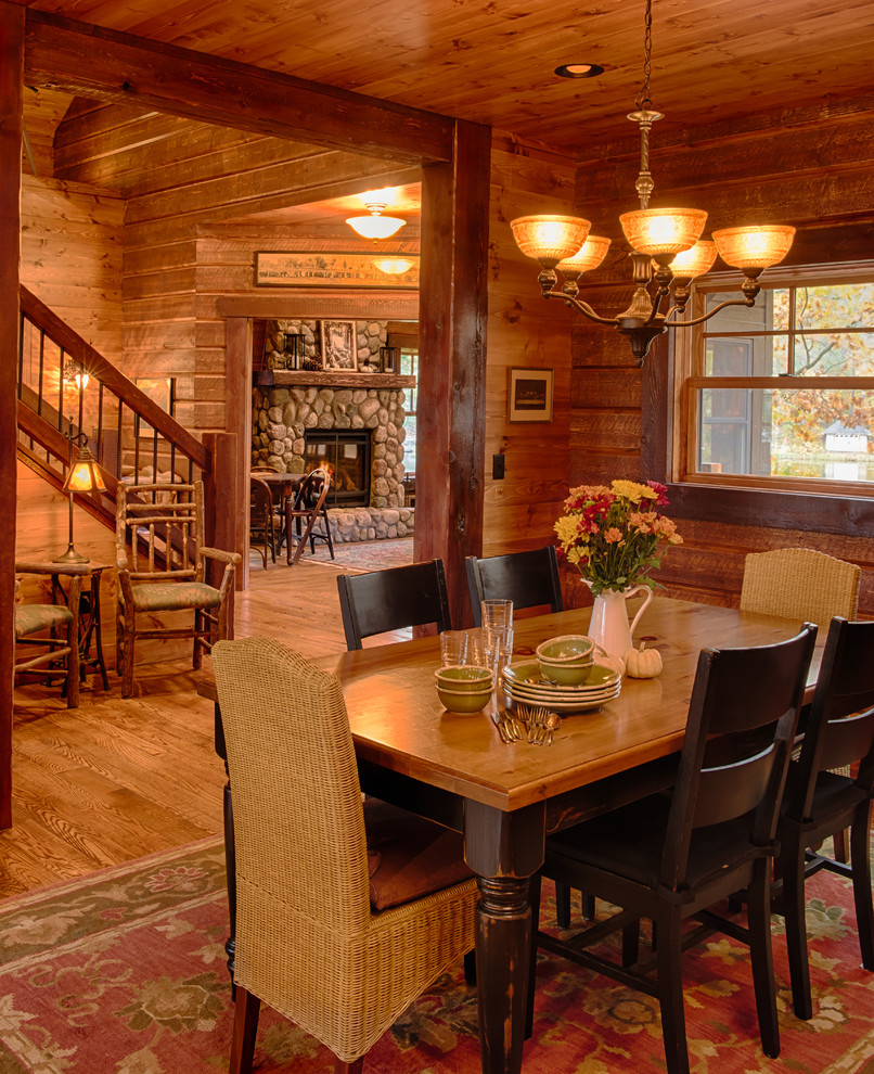 Mountain style medium tone wood floor kitchen/dining room combo photo in Minneapolis with brown walls