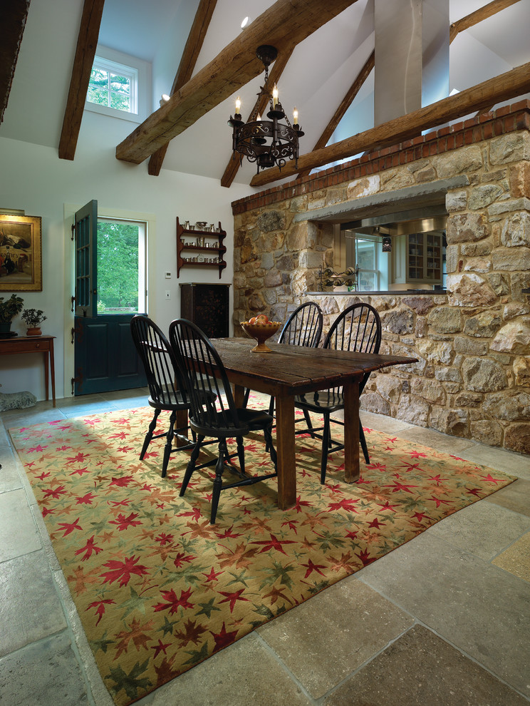 Example of a mid-sized mountain style limestone floor dining room design in Wilmington with white walls and no fireplace