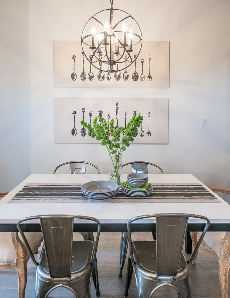 Example of a transitional dining room design in Calgary with white walls