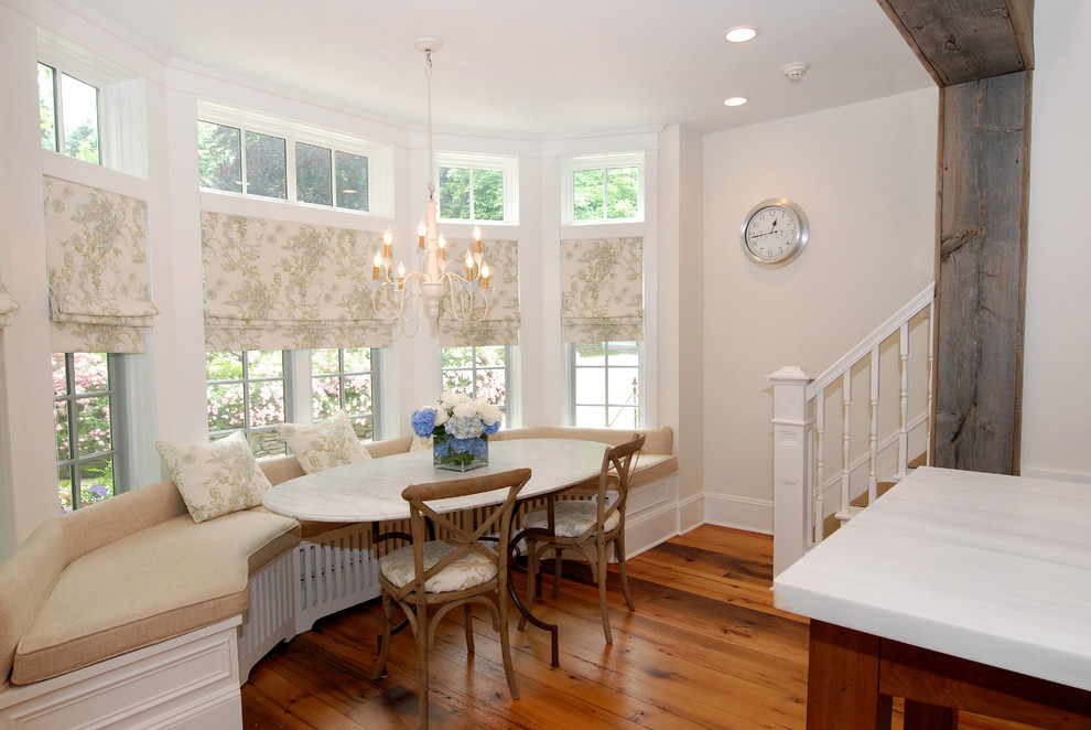 Example of a large mountain style medium tone wood floor kitchen/dining room combo design in New York with white walls and no fireplace