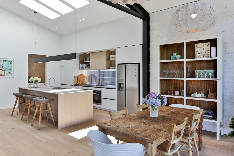 Inspiration for a small rustic light wood floor and brown floor great room remodel in Auckland with white walls