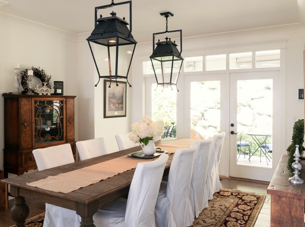 Inspiration pour une grande salle à manger ouverte sur la cuisine style shabby chic avec un mur blanc et un sol en bois brun.
