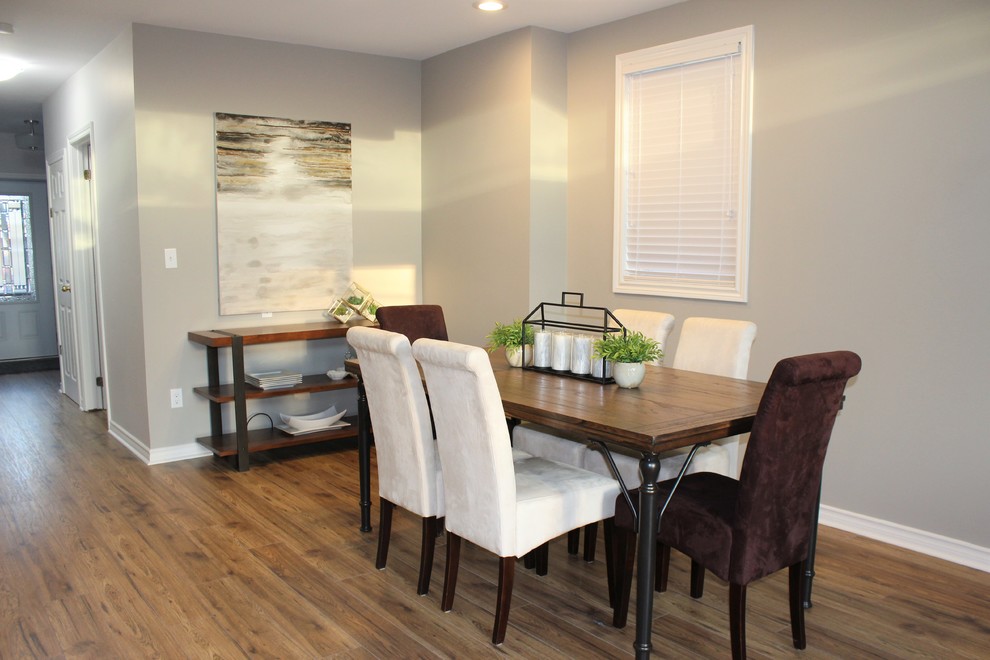 Example of a small transitional laminate floor and brown floor dining room design in Other with beige walls